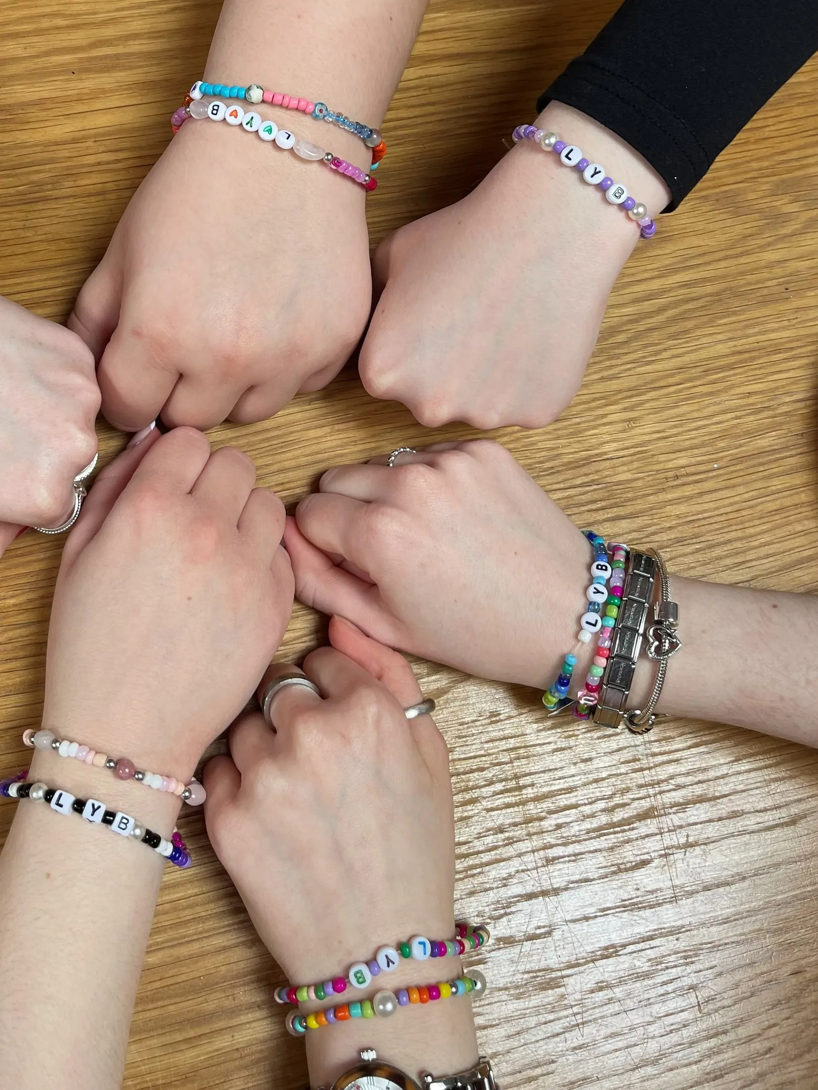 Hands together, showing off friendship bracelets