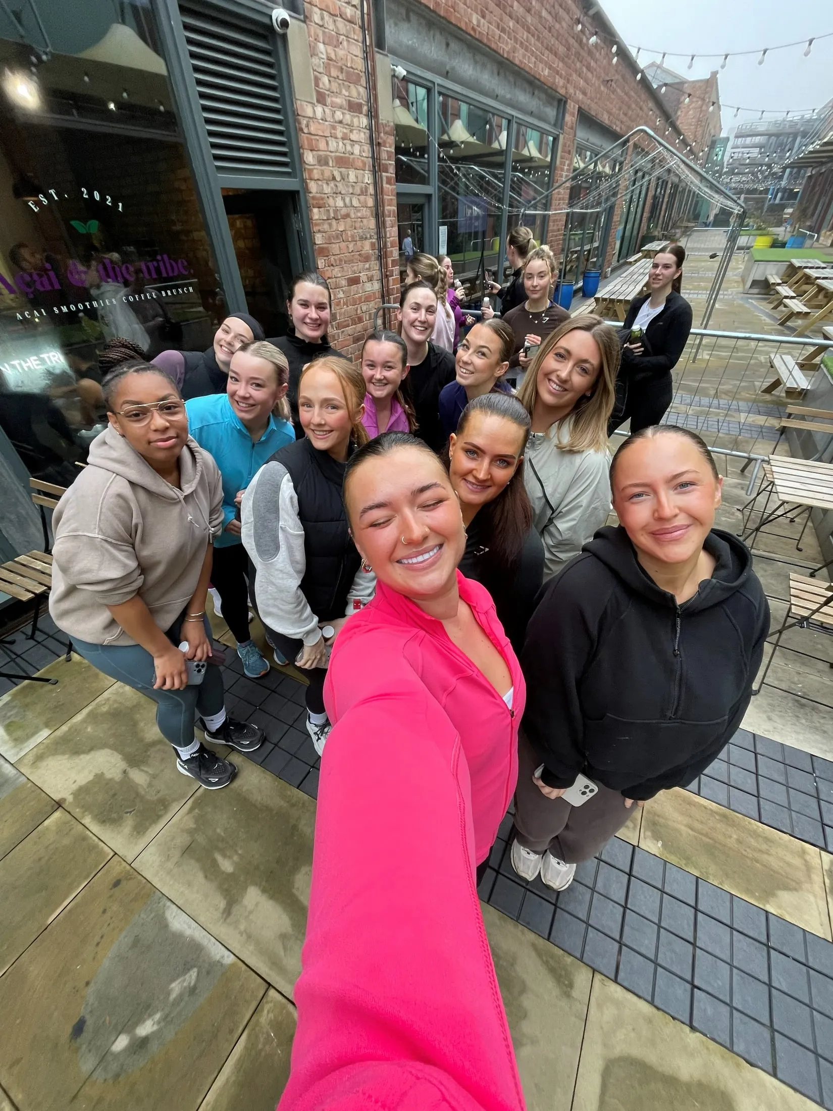 A group selfie outside, in front of a brick building