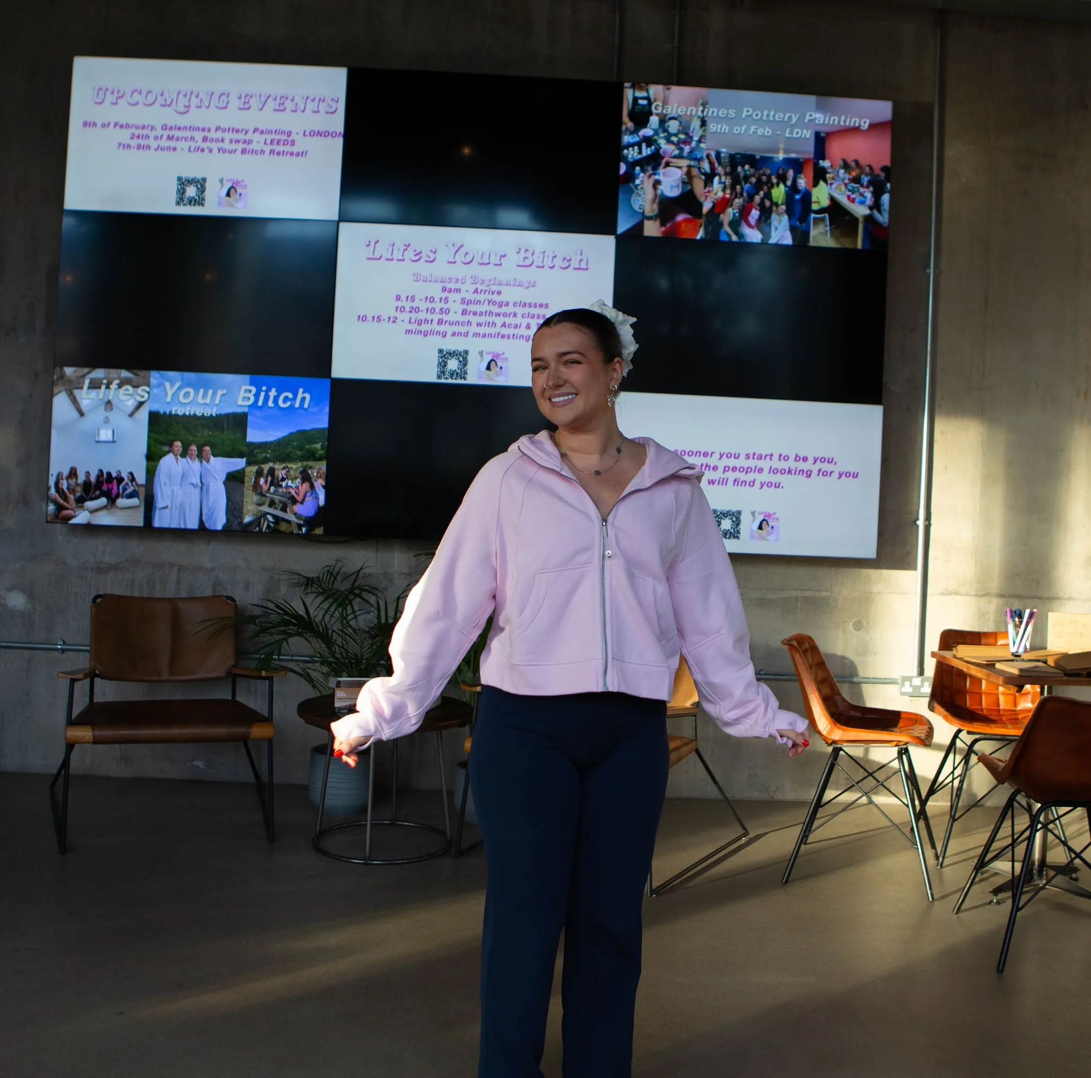 Megan at a Life's Your Bitch event, in front of a screen of event photos