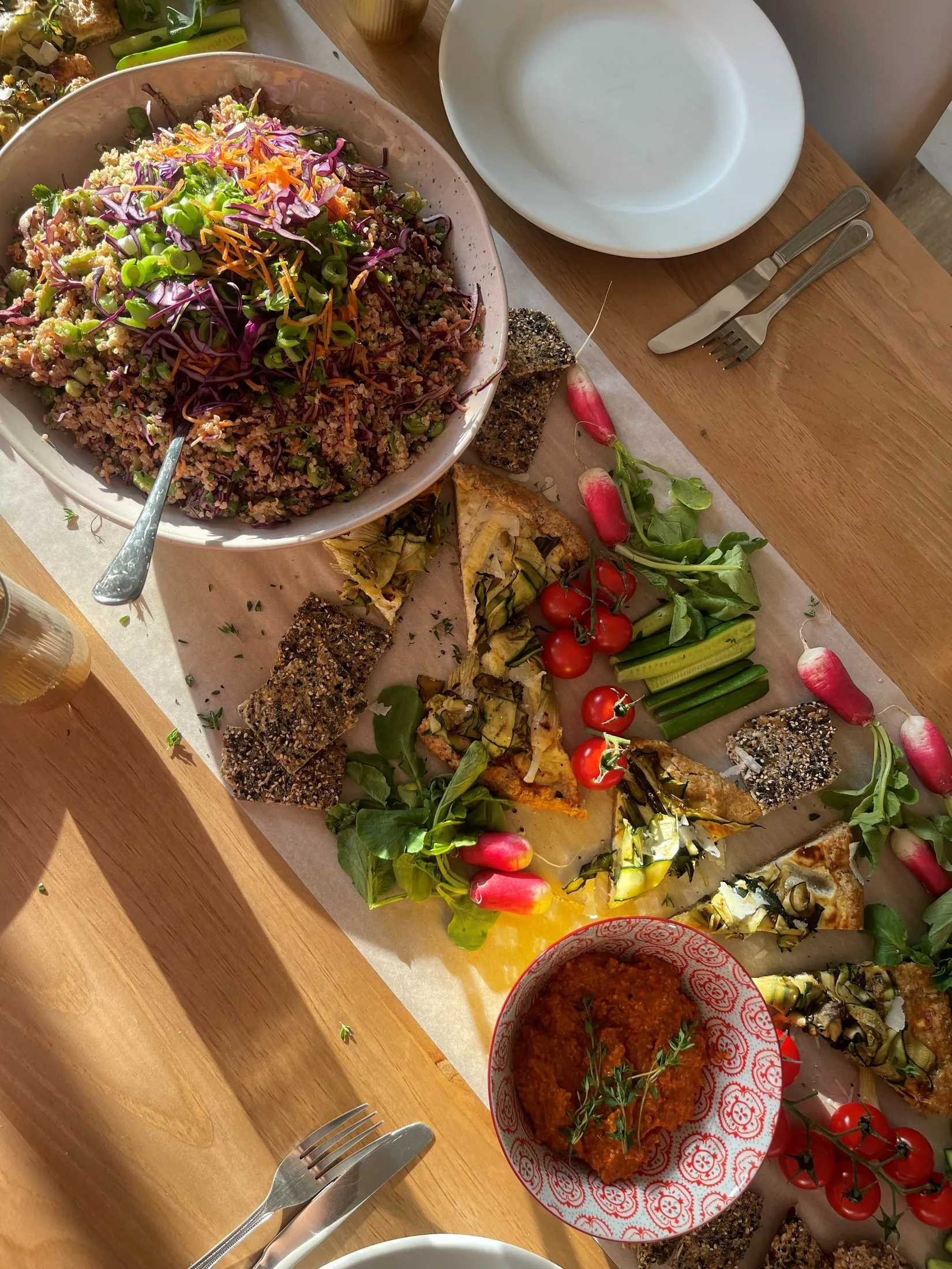 A long table of salads and roasted vegetables, seen from above